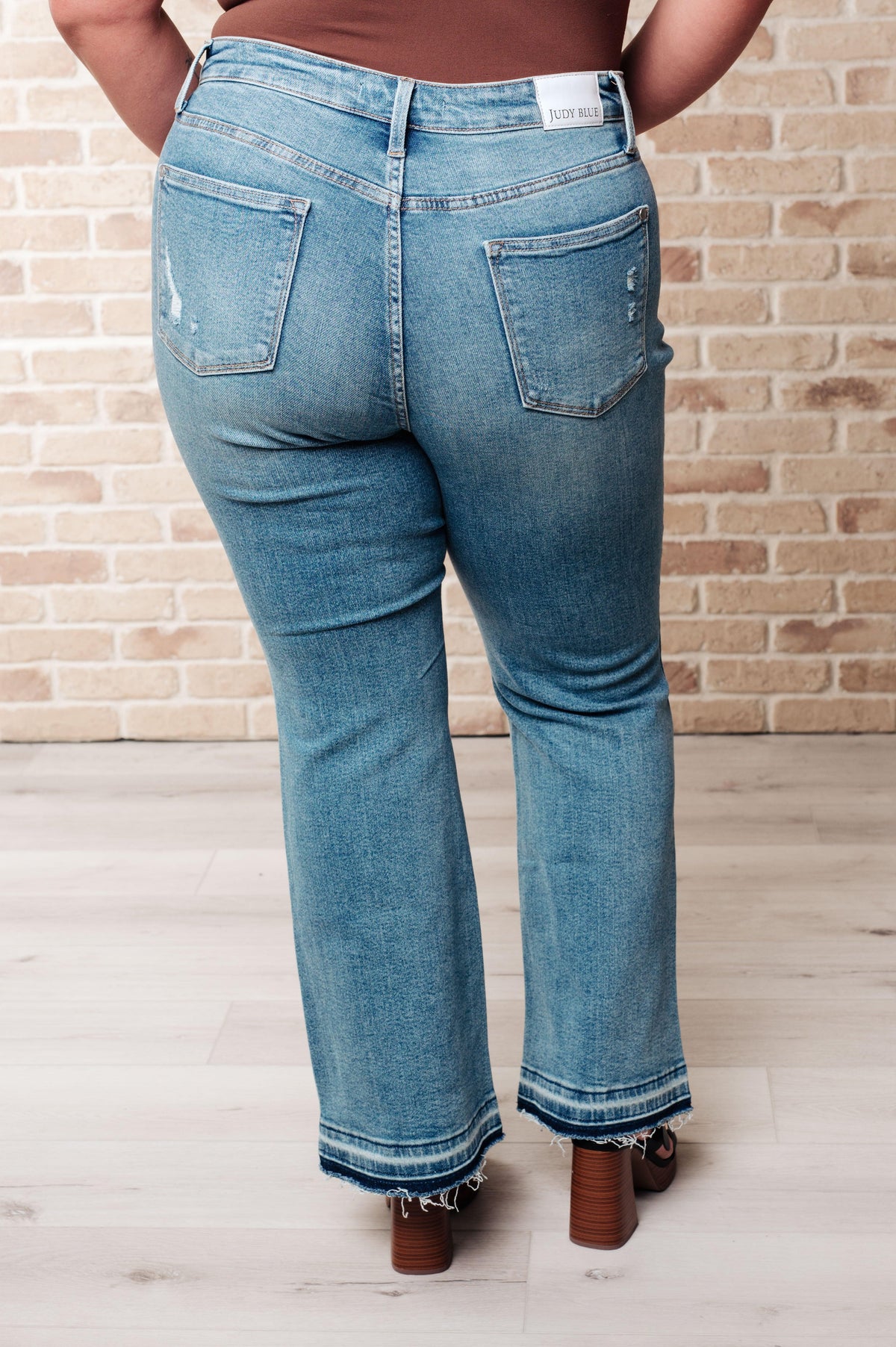 Judy Blue | Isla Mid Rise Distressed Released Hem Bootcut Jeans - becauseofadi